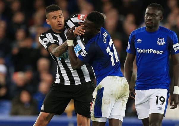 Newcastle United's Kenedy tuddles with Everton's Idrissa Gueye.
