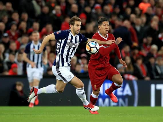 Craig Dawson battles with Roberto Firmino.