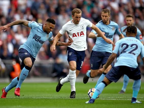 Harry Kane and Jamaal Lascelles, left