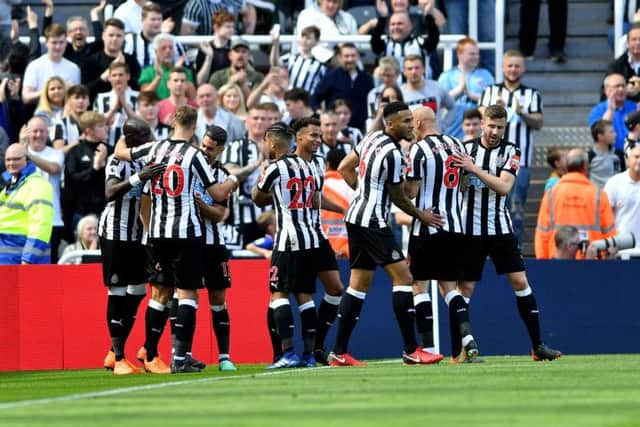 Newcastle United players celebrate Dwight Gayles early goal against Chelsea,