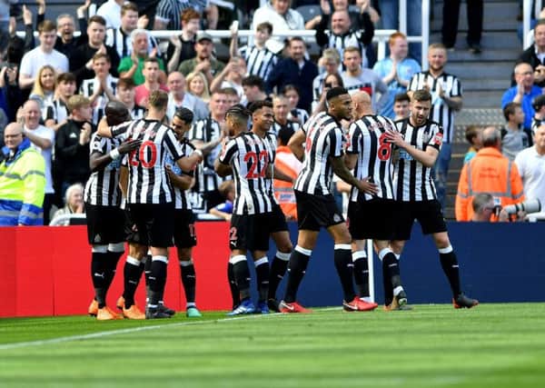 Newcastle United players celebrate Dwight Gayles early goal against Chelsea,