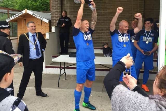 Martyn Waghorn lifts the trophy.