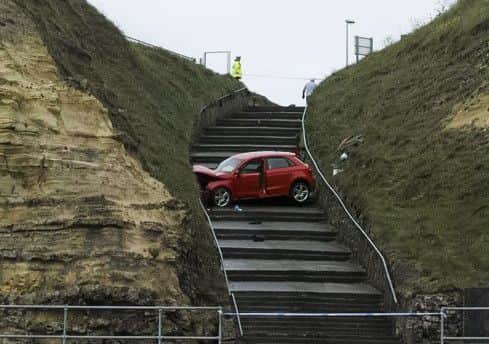 A damaged car lies halfway down the steps to Marsden beach, South Shields. Pic: Robin Hunter.