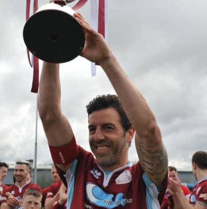 Julio Arca hoists the Evo-Stik North championship trophy for South Shields. Picture by Tim Richardson