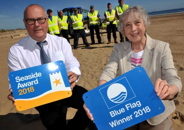 Coun Moira Smith and Outdoor Facilities OfficerAlan Maving with the Blue Flag and Seaside Awards.