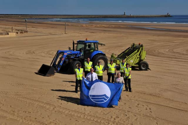 Families enjoy sunny weather on Sandhaven Beach.