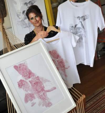 Artist Jane Lee McCracken with her Newcastle and Sunderland inspired T-shirt designs.