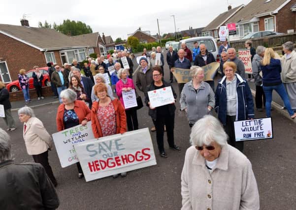 Residents protest over the housing development plan.