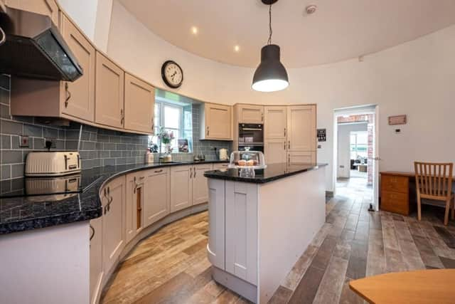 The kitchen offers a bespoke, fitted Shaker-style kitchen which runs around the circular wall of the windmill. (Picture: Reeds Rains)